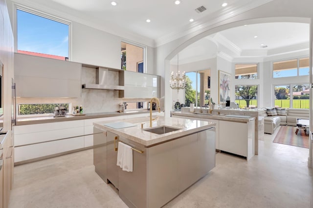 7090 Ayrshire Ln, Boca Raton, FL 33496 - kitchen with modern cabinets, a sink, wall chimney range hood, arched walkways, and crown molding