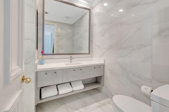 7090 Ayrshire Ln, Boca Raton, FL 33496 - bathroom with tile walls, crown molding, toilet, marble finish floors, and vanity