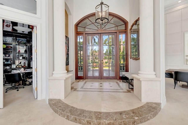7090 Ayrshire Ln, Boca Raton, FL 33496 - foyer entrance with ornate columns, french doors, arched walkways, and a chandelier
