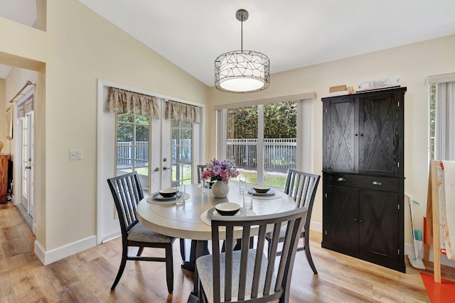 dining space with french doors, a healthy amount of sunlight, and light wood-style floors