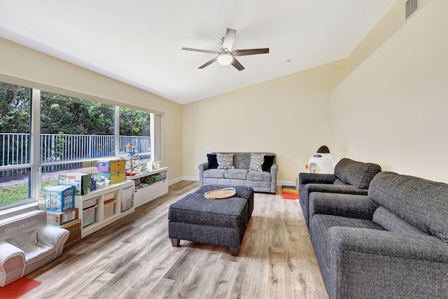 living room with lofted ceiling, wood finished floors, ceiling fan, and visible vents