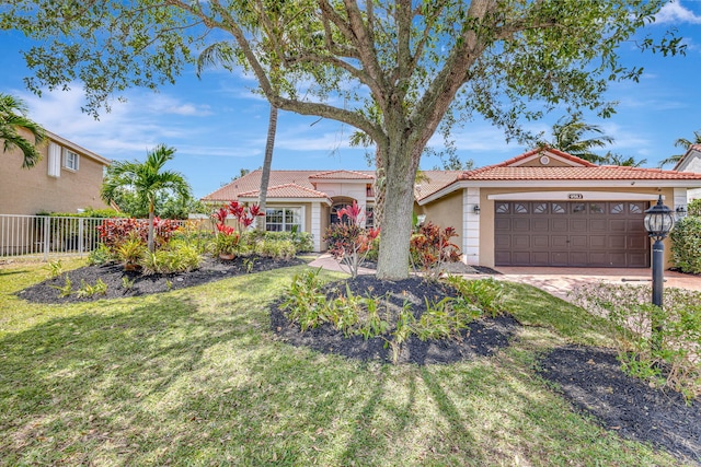 view of front of home featuring a garage, fence, stucco siding, and a tiled roof