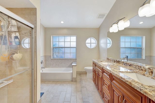 bathroom with double vanity, visible vents, a shower stall, and a sink