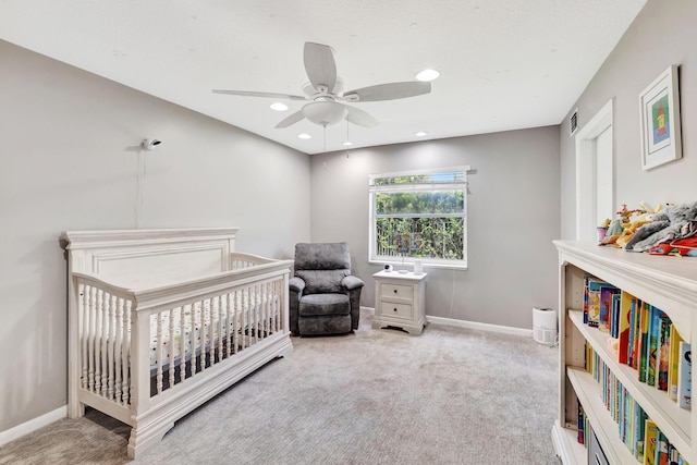 carpeted bedroom with ceiling fan, visible vents, baseboards, a crib, and recessed lighting