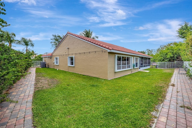 view of home's exterior with stucco siding, a yard, and a fenced backyard