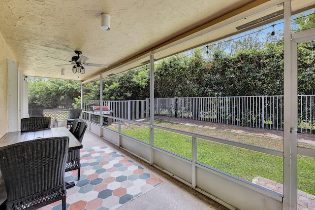 sunroom / solarium featuring ceiling fan