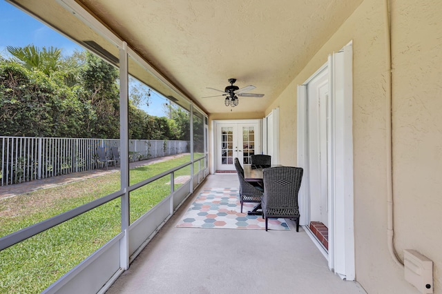 sunroom featuring french doors and ceiling fan