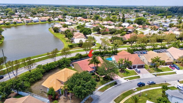 drone / aerial view featuring a residential view and a water view