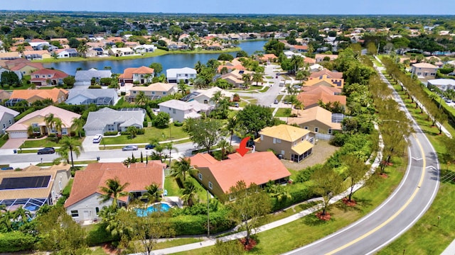 drone / aerial view with a residential view and a water view