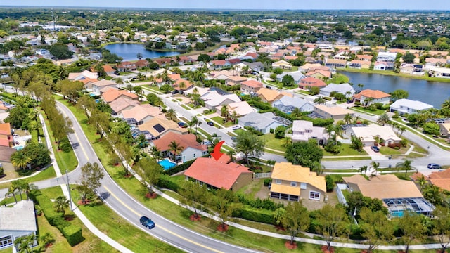 bird's eye view featuring a water view and a residential view