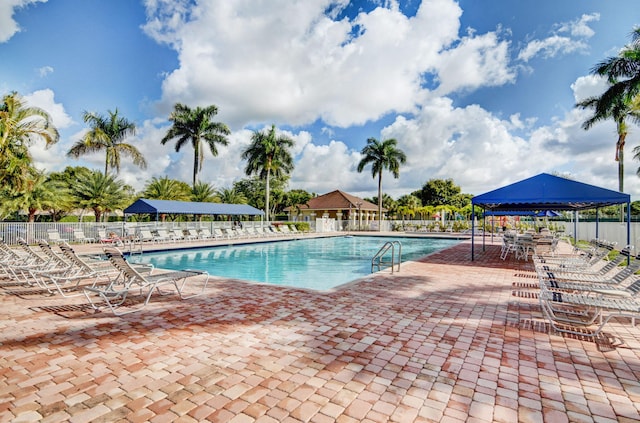 pool featuring a patio, a gazebo, and fence