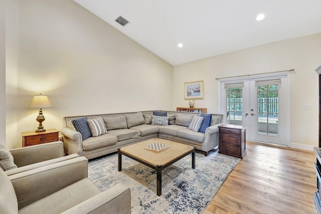 living room with visible vents, baseboards, light wood-type flooring, recessed lighting, and french doors