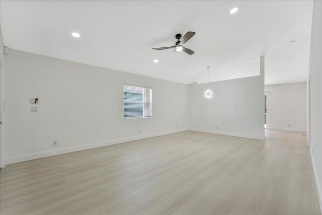 unfurnished room with a ceiling fan, baseboards, recessed lighting, and light wood-style flooring