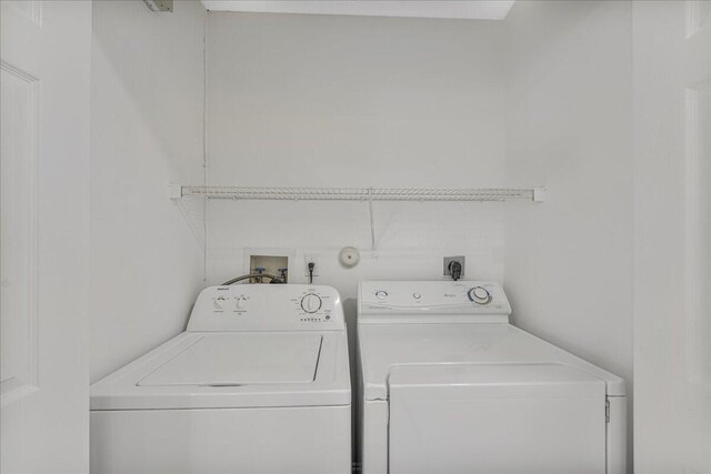 clothes washing area featuring laundry area and washing machine and dryer