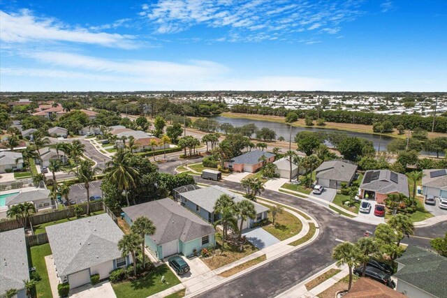 drone / aerial view with a water view and a residential view