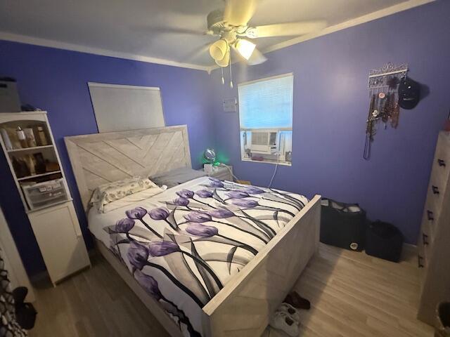 1126 S L St, Lake Worth Beach, FL 33460 - bedroom featuring crown molding, ceiling fan, cooling unit, and wood finished floors
