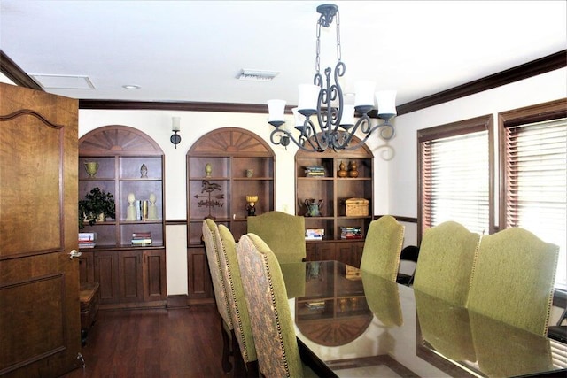 dining room featuring built in shelves, a notable chandelier, crown molding, visible vents, and dark wood finished floors