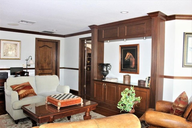 living room featuring visible vents, crown molding, and recessed lighting