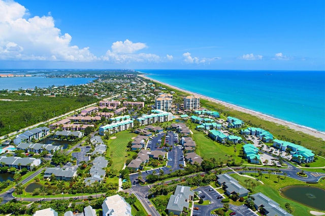 drone / aerial view featuring a water view and a view of the beach