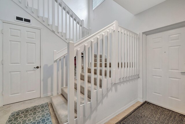 stairs featuring baseboards and visible vents