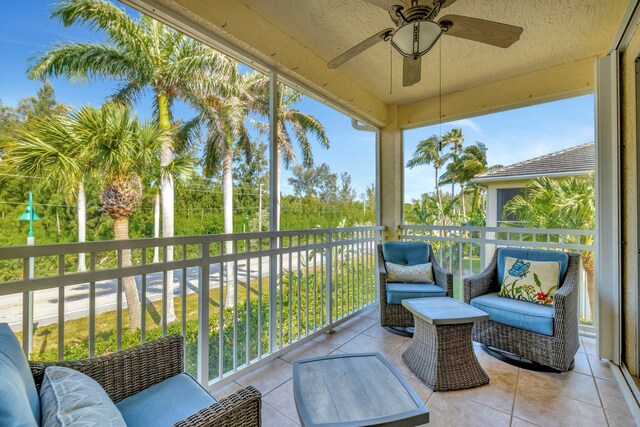sunroom with an outdoor living space and ceiling fan