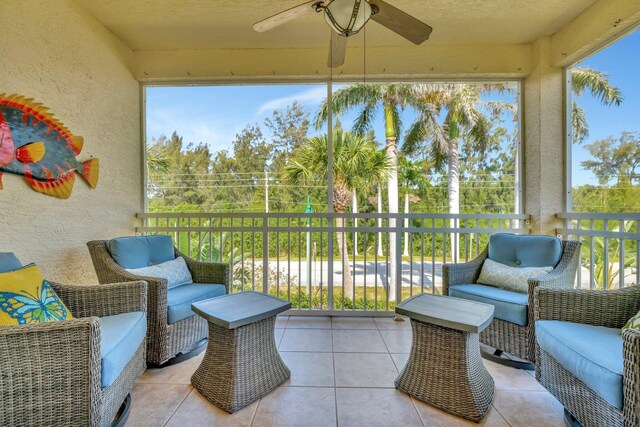 sunroom featuring ceiling fan and plenty of natural light