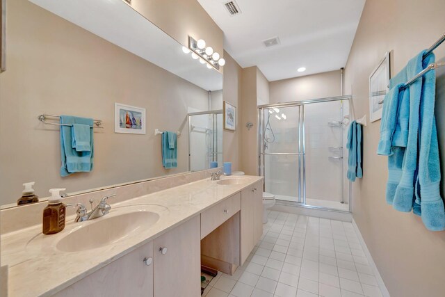bathroom with visible vents, a shower stall, a sink, and tile patterned flooring