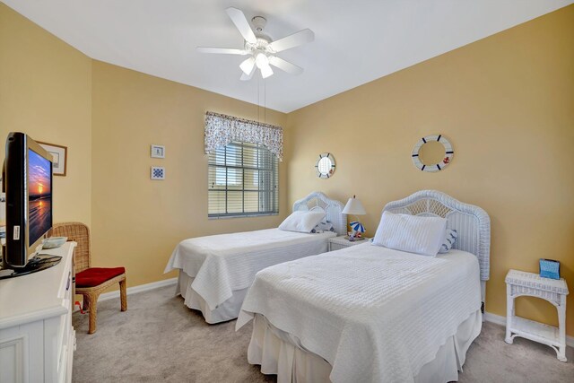 bedroom featuring baseboards, ceiling fan, and light colored carpet
