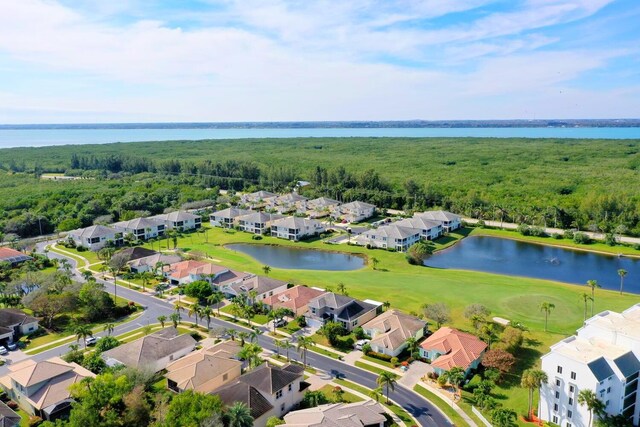 birds eye view of property with a residential view, view of golf course, a water view, and a forest view