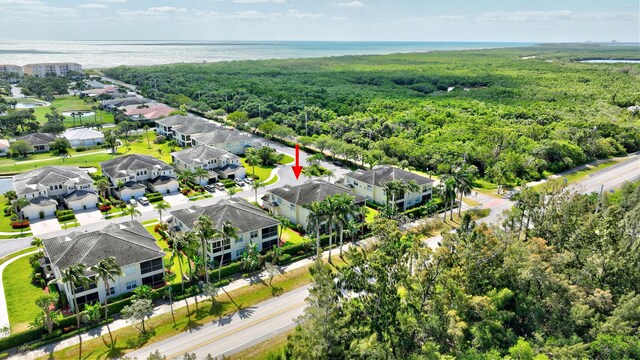 aerial view with a residential view, a water view, and a wooded view