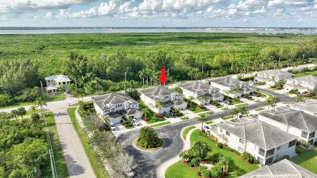 aerial view featuring a water view, a residential view, and a wooded view