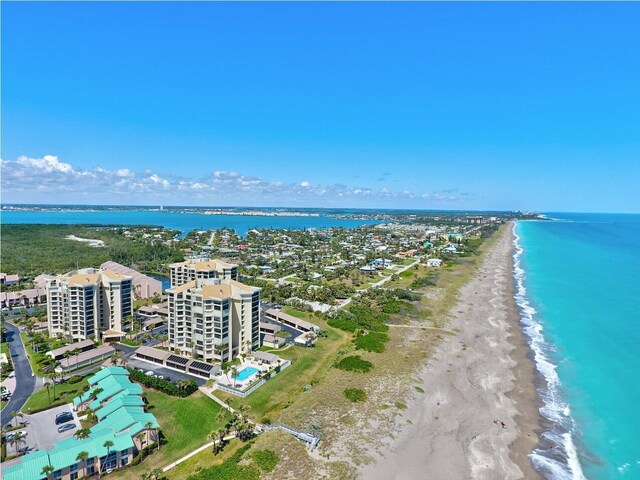 birds eye view of property featuring a view of the beach and a water view