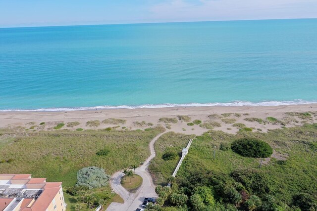 bird's eye view with a water view and a view of the beach
