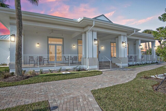 view of front of home with a porch and stucco siding