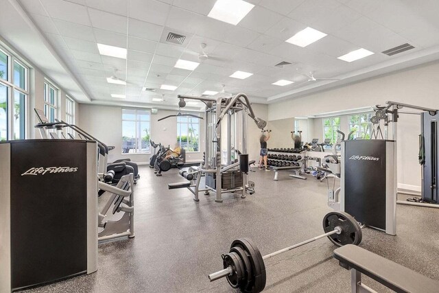 workout area with visible vents and a paneled ceiling