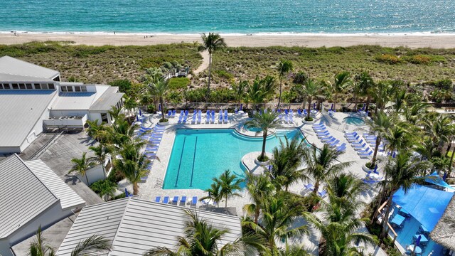 bird's eye view featuring a water view and a beach view
