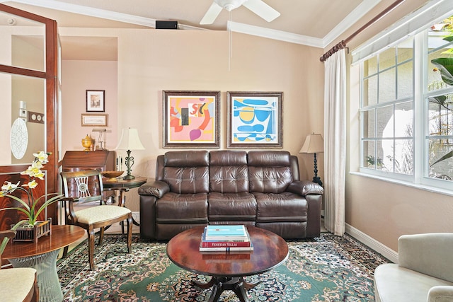 living room with a ceiling fan, ornamental molding, and baseboards