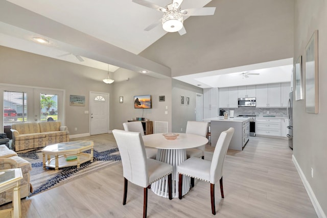 4059 Gator Trace Rd, Fort Pierce, FL 34982 - dining room featuring ceiling fan, baseboards, high vaulted ceiling, light wood-style flooring, and recessed lighting