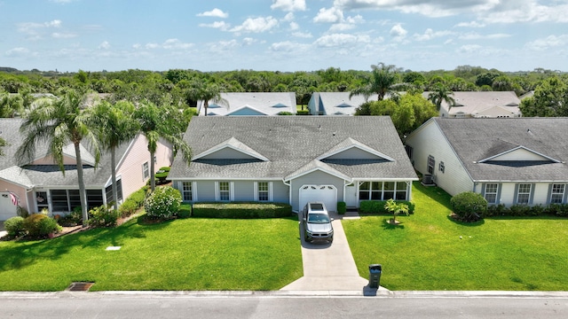 4059 Gator Trace Rd, Fort Pierce, FL 34982 - view of front of house featuring concrete driveway, a shingled roof, a garage, and a front yard