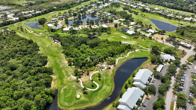 birds eye view of property with a water view, view of golf course, and a residential view