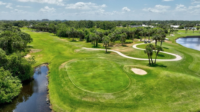 surrounding community with view of golf course and a water view
