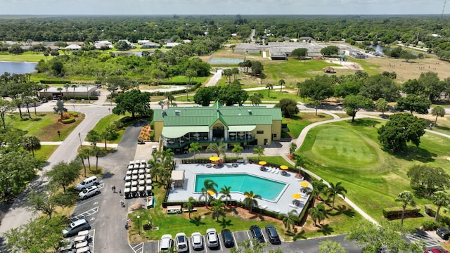 drone / aerial view with a water view and view of golf course