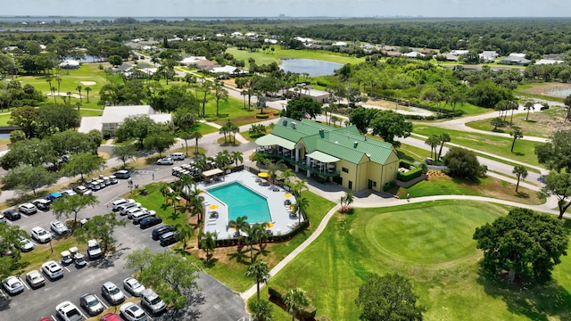 birds eye view of property with view of golf course and a water view