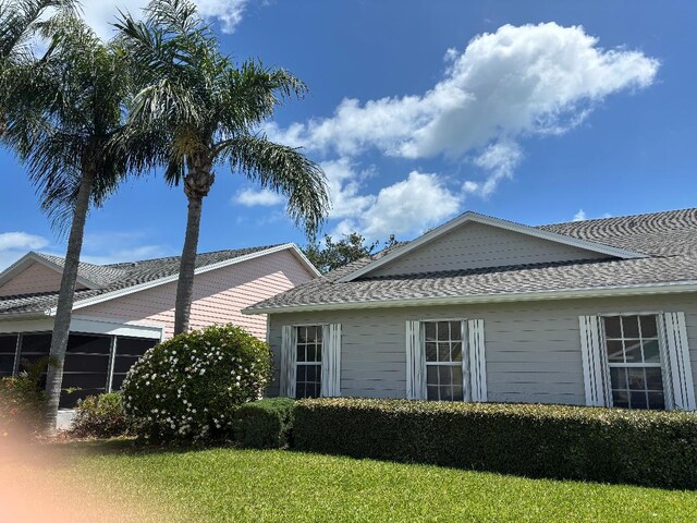 4059 Gator Trace Rd, Fort Pierce, FL 34982 - view of side of property with roof with shingles and a yard