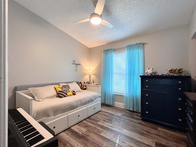 6446 Terra Rosa Cir, Boynton Beach, FL 33472 - bedroom with a textured ceiling, lofted ceiling, wood finished floors, and ceiling fan