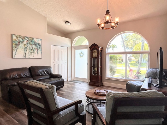 6446 Terra Rosa Cir, Boynton Beach, FL 33472 - living room with a chandelier, a textured ceiling, wood finished floors, and lofted ceiling