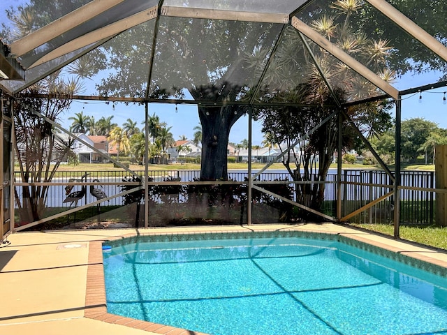 6446 Terra Rosa Cir, Boynton Beach, FL 33472 - view of swimming pool with glass enclosure, a fenced backyard, and a water view