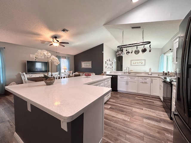 6446 Terra Rosa Cir, Boynton Beach, FL 33472 - kitchen with lofted ceiling, a sink, black appliances, light countertops, and open floor plan