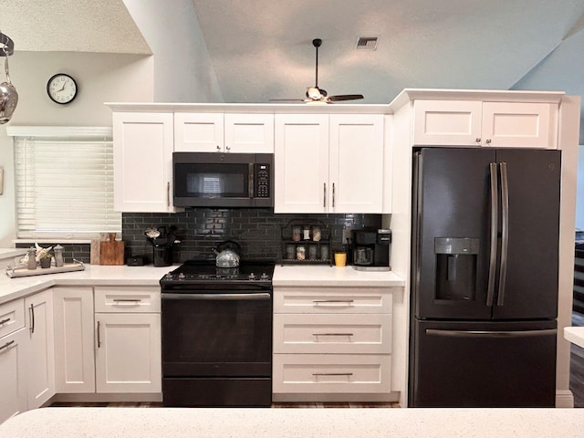 6446 Terra Rosa Cir, Boynton Beach, FL 33472 - kitchen featuring black appliances, white cabinets, tasteful backsplash, light countertops, and vaulted ceiling