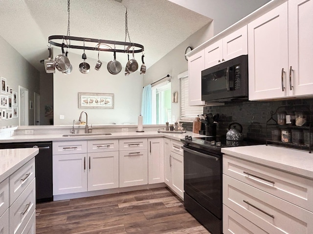 6446 Terra Rosa Cir, Boynton Beach, FL 33472 - kitchen with black appliances, a sink, light countertops, backsplash, and white cabinetry